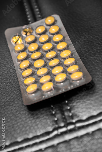 Yellow coated tablet in blister pack