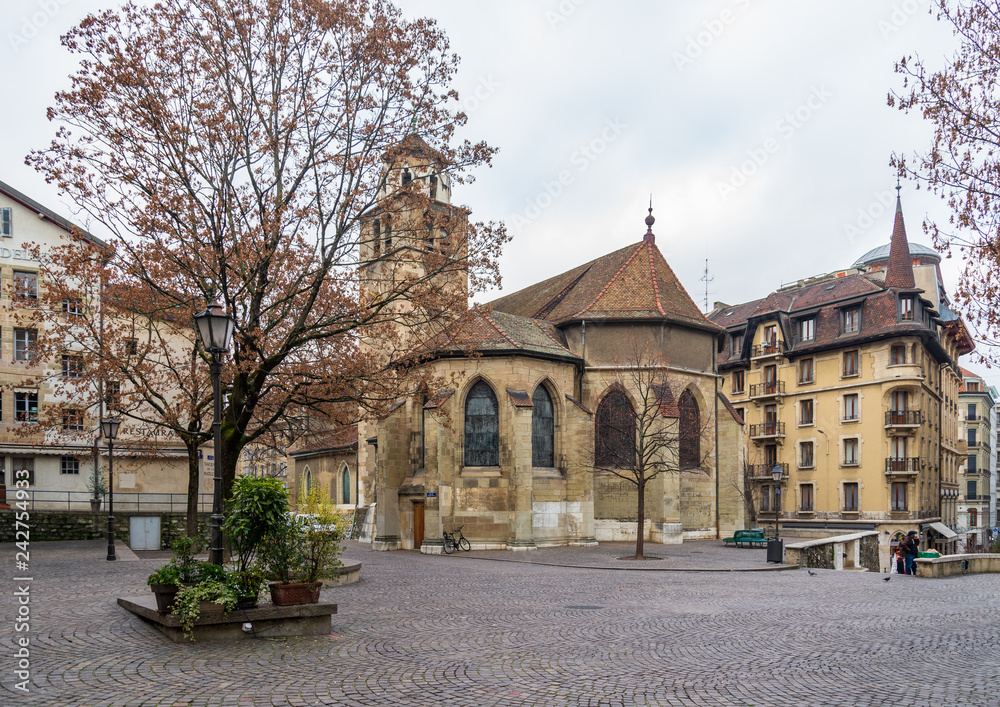 Medieval stone church on pocket park in old town Geneva, Switzerland with cloudy sky. Medieval stone church on pocket park in old town Geneva, Switzerland with cloudy sky.