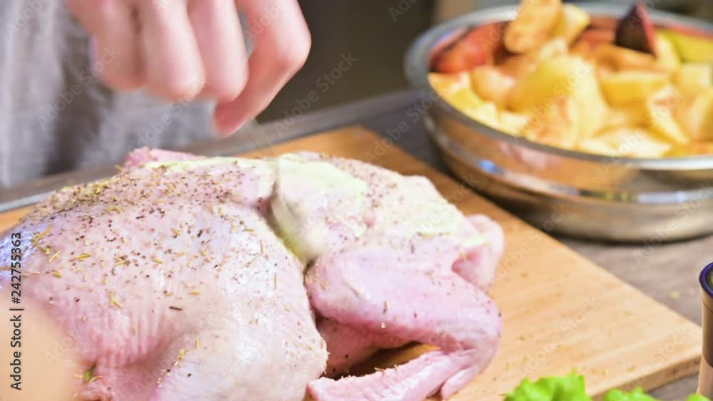 Close-up of female hands preparing duck or goose for baking. White carrot dressing with mayonnaise. Christmas dish duck goose with apples