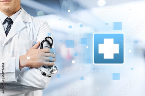 Male doctor with stethoscope on blurred hospital background