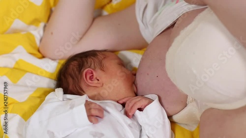 Newborn baby sleeping peacefully over the mother chest. Breastfeeding tips concept. Basis of motherhood.