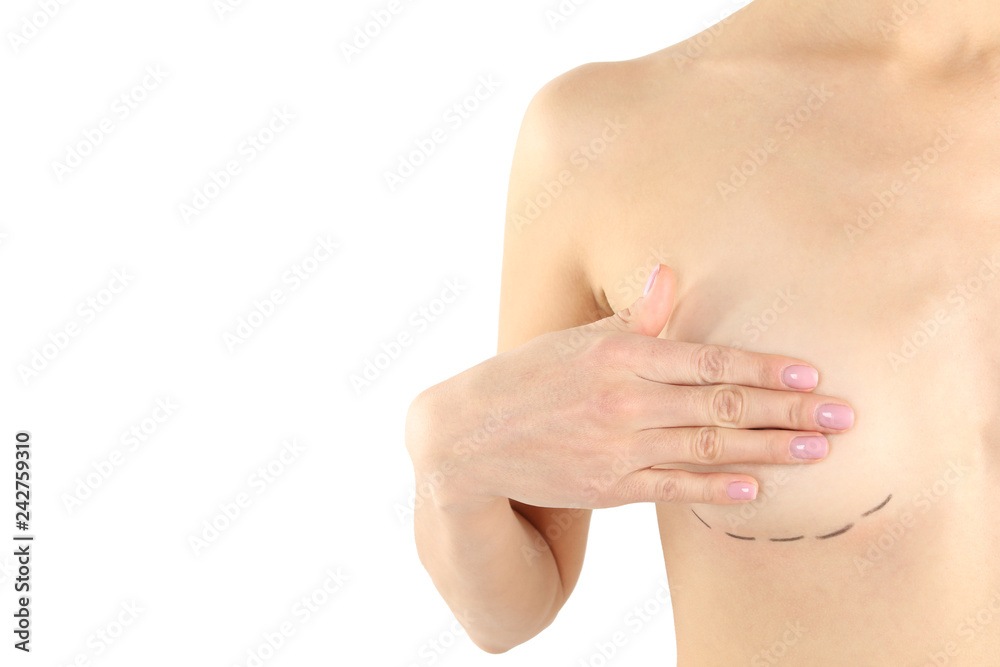 Fototapeta premium Young woman with marks on breast for cosmetic surgery operation against white background, closeup