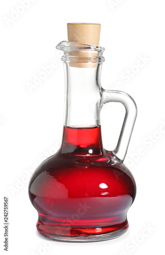 Glass jug with wine vinegar on white background