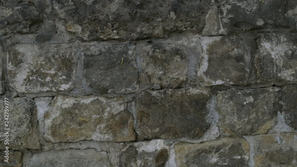 Detail of natural gray stone wall texture. Old vintage. Buildings background. Close-up. Detail of natural gray stone wall texture. Old vintage. Buildings background. Close-up.