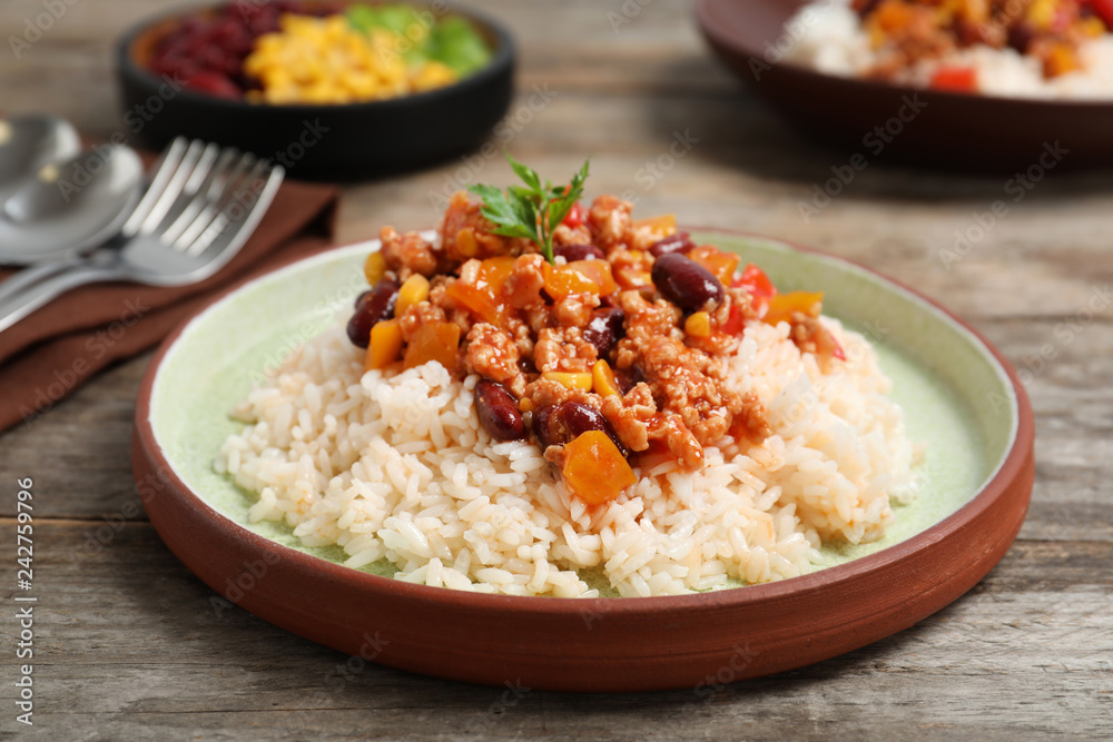 Chili con carne served with rice on table Chili con carne served with rice on table