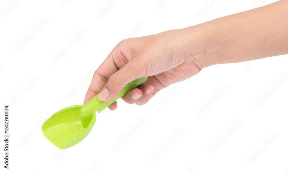 hand holding Small plastic toy shovel isolated on a white background