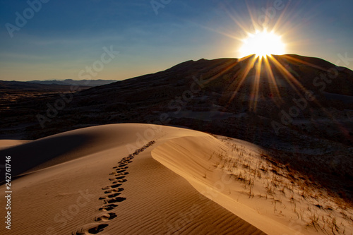 sand dune sunset footprints photo