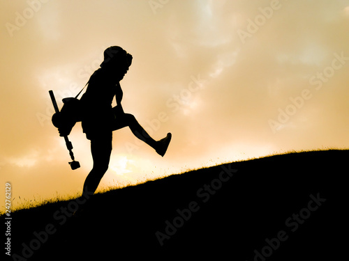 silhouette of tourist hiker acting on top of mountain