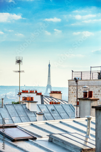 Eiffel tower behind the city rooftops, Paris, France