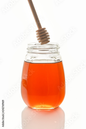 Bee honey with a wooden spoon for honey.isolated objects on white background