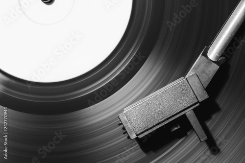 Picture of a vinyl record playing in black and white