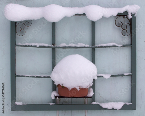 Decorative window frame covered with snow