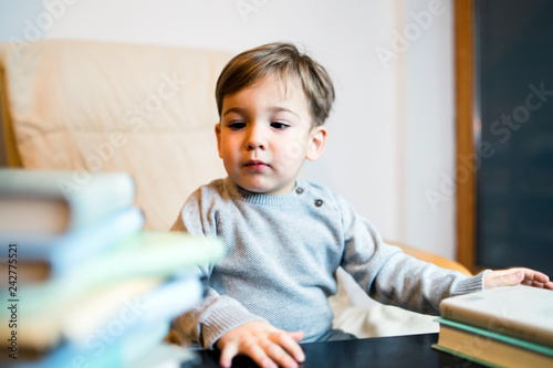 Little Boy PLaying With Books Reading
