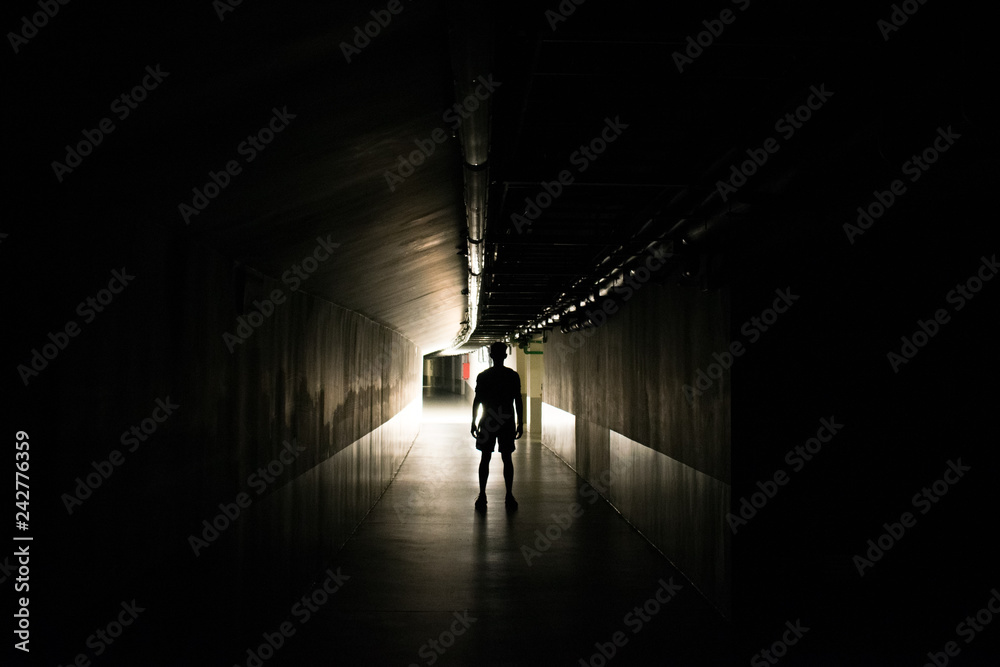 Man in a dark tunnel