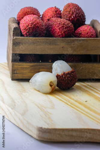 fresh lychee in a wooden box on white backgroud