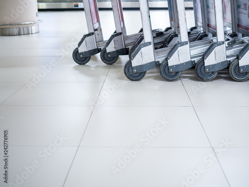 Row of airport luggage carts in airport terminal
