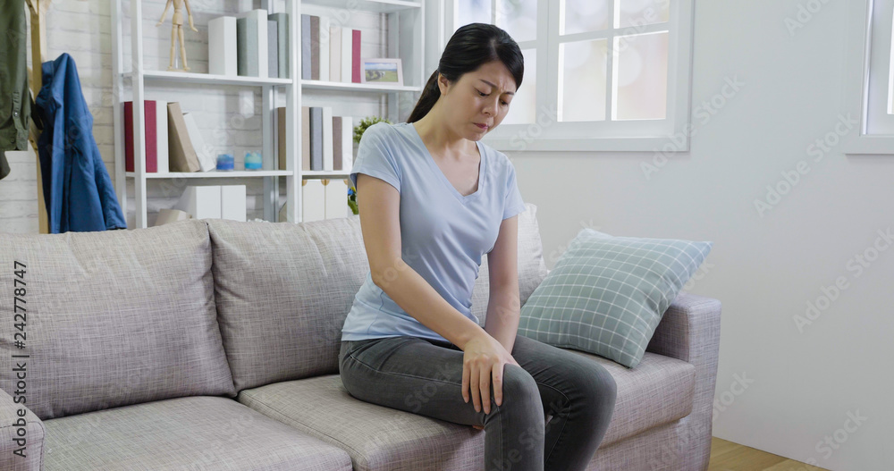asian lady massage hurts knee in sofa. asian lady massage hurts knee in sofa.
