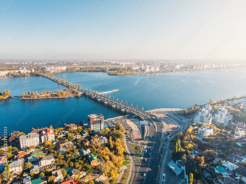 Aerial drone shot of Voronezh city downtown with buildings, Chernavsky bridge and car traffic from above