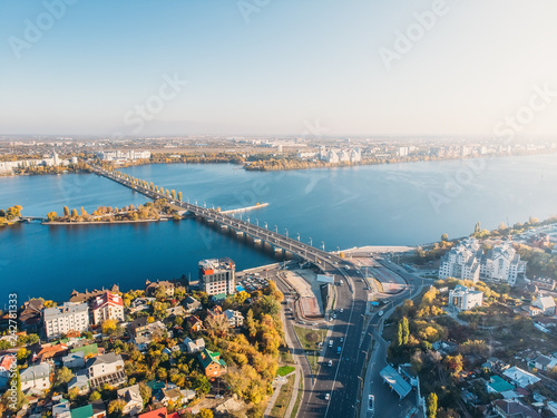 Aerial drone shot of Voronezh city downtown with buildings, Chernavsky bridge and car traffic from above