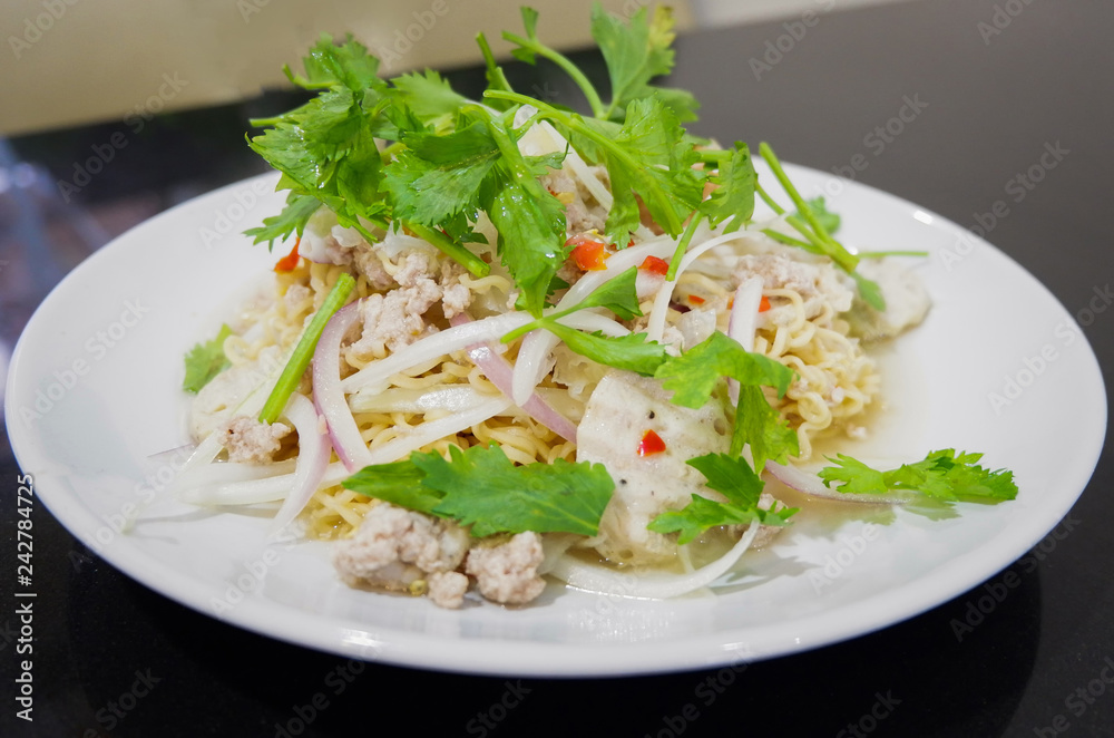 Instant noodle spicy salad Thai style food on white plate