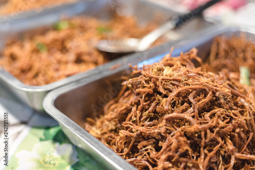 Shredded pork on a tray with another thing in blurred background