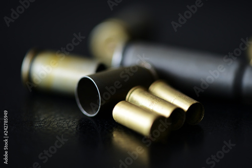Empty old bullet cartridges on a dark background close up