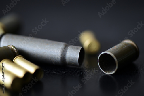 Empty old bullet cartridges on a dark background close up