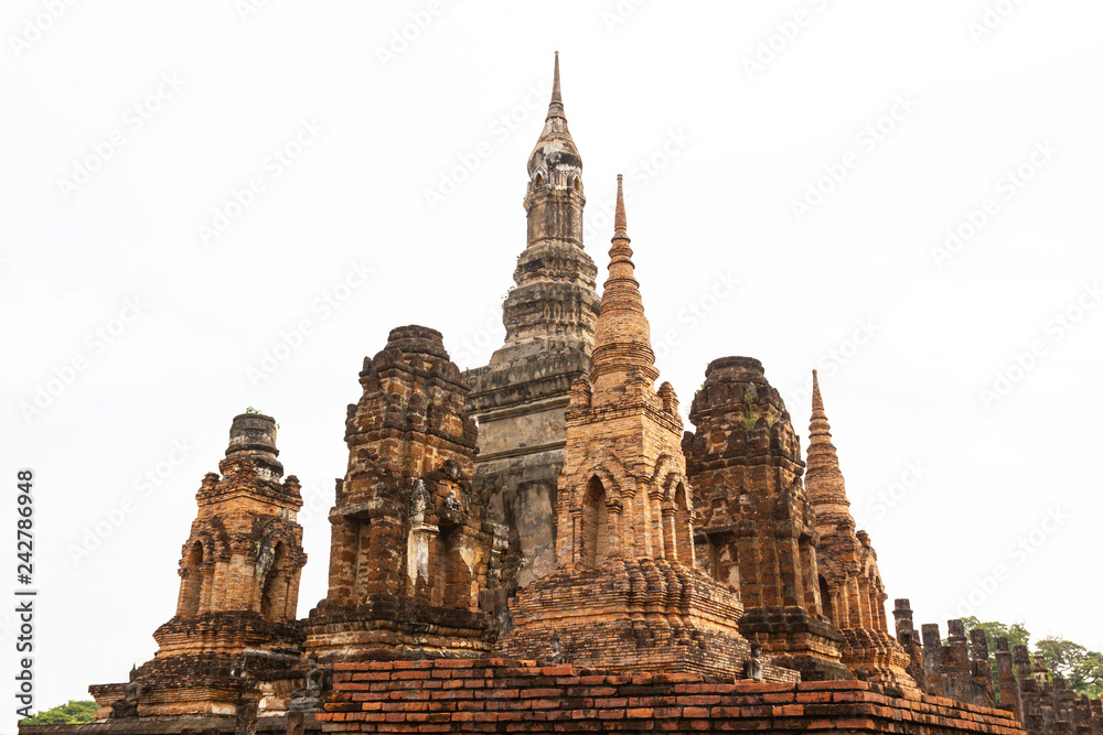 Fototapeta premium Sukhothai, Thailand, Buddha statues at with ruins and ancient Wat Mahathat ancient capital of Sukhothai, Thailand. Sukhothai Historical Park is the UNESCO world heritage