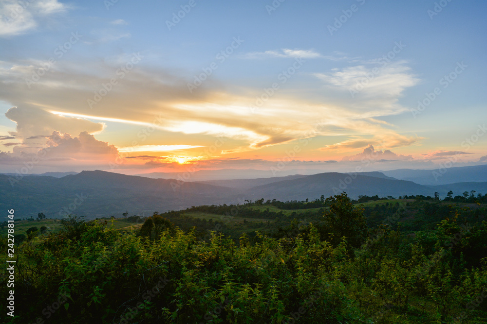 beautiful clouds Sunset Dramatic colorful of yellow and blue sky on hill with field on mountain landscape sunset