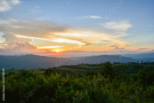 beautiful clouds Sunset Dramatic colorful of yellow and blue sky on hill with field on mountain landscape sunset