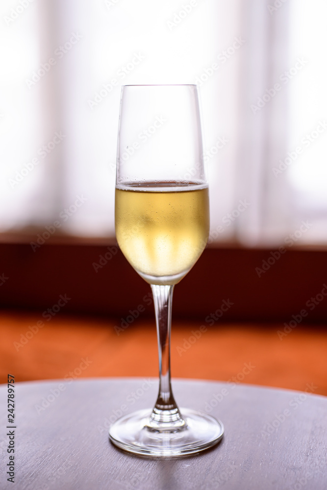 champagne glass with blurred curtain background champagne glass with blurred curtain background