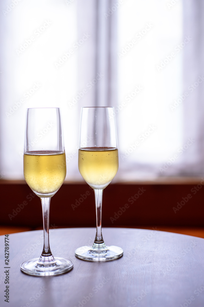 champagne glass with blurred curtain background champagne glass with blurred curtain background