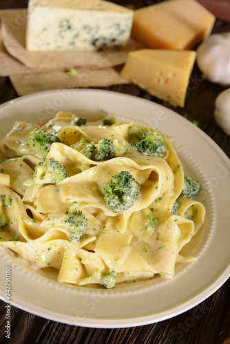 Tagliatelle pasta with cheese sauce and broccoli