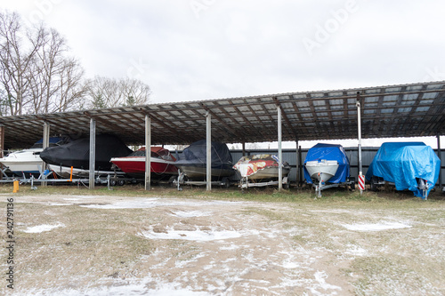 boats covered with covers in Parking. storage of ship in winter