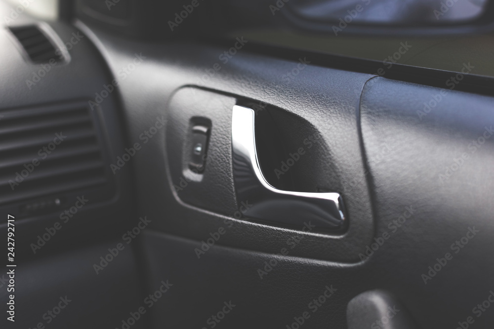 Handle opening the car door. Car interior.