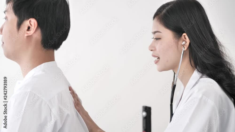 Asian doctor with breathing and back examination for her patient, work concept. Asian doctor with breathing and back examination for her patient, work concept.