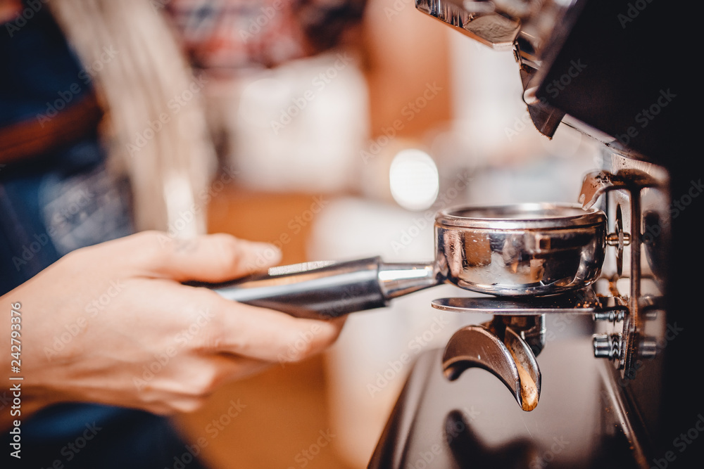 Hands baristas holding fine grinding of coffee for espresso.