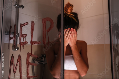 Scared victim in shower cab...
