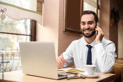 Young businessman talking o...