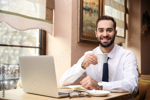 Young businessman drinking ...