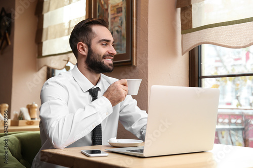 Young businessman drinking ...