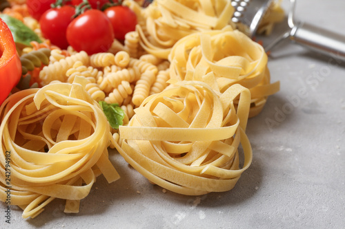 Raw pasta on grey background