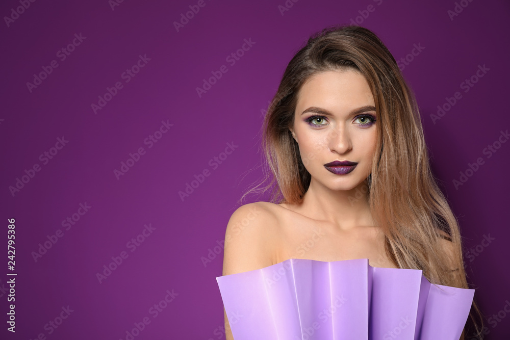 Beautiful young woman on violet background Beautiful young woman on violet background