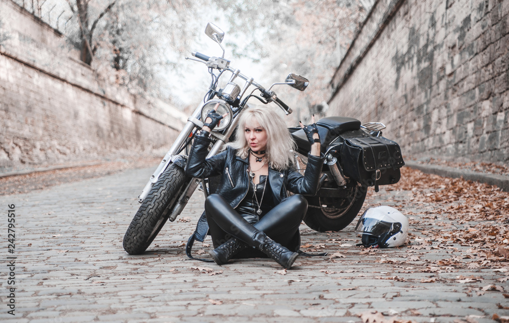 Woman with motorcycle on the road.
Woman with motorcycle on the road.