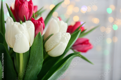 Bouquet of beautiful tulips against defocused lights