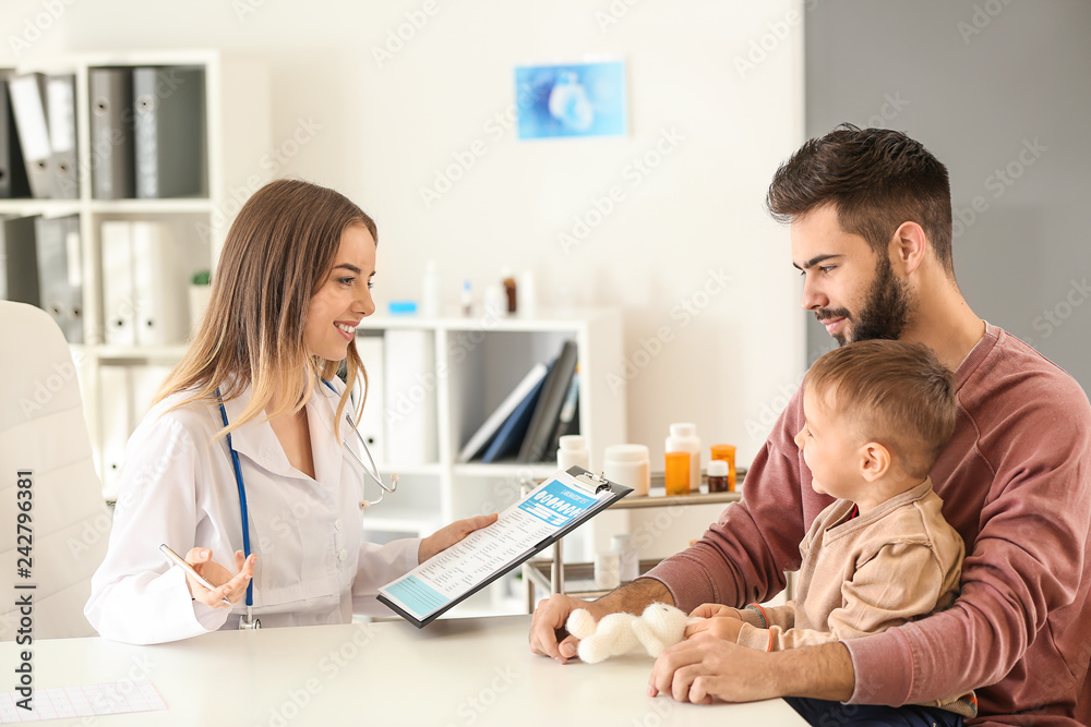 Young father with his little son visiting doctor in clinic Young father with his little son visiting doctor in clinic