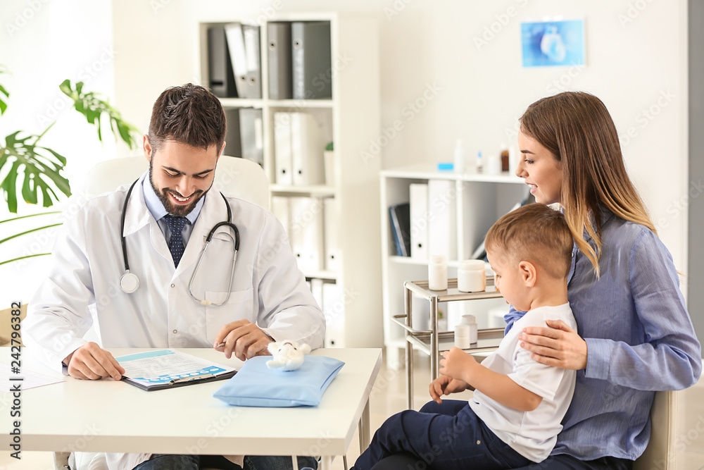 Young mother with her little son visiting doctor in clinic Young mother with her little son visiting doctor in clinic
