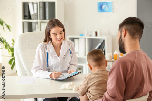 Young father with his little son visiting doctor in clinic