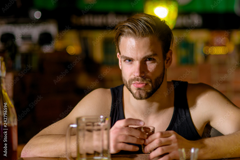 Grabbing a drink after work. Man drink strong alcoholic beverage and