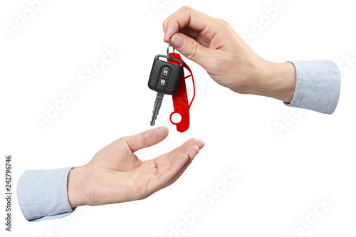Two hands, giving and taking a car key, isolated on white background